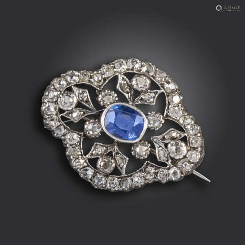 A Victorian sapphire and diamond quatrefoil brooch, the oval-shaped sapphire is set within foliate