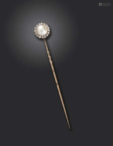A Victorian natural pearl and diamond stick pin, the natural half pearl set within a surround of old