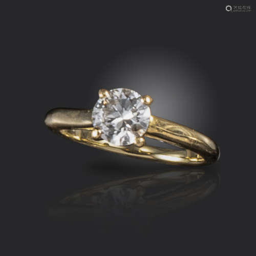 A diamond solitaire ring by Cartier, the round brilliant-cut diamond weighs approximately 0.70cts,