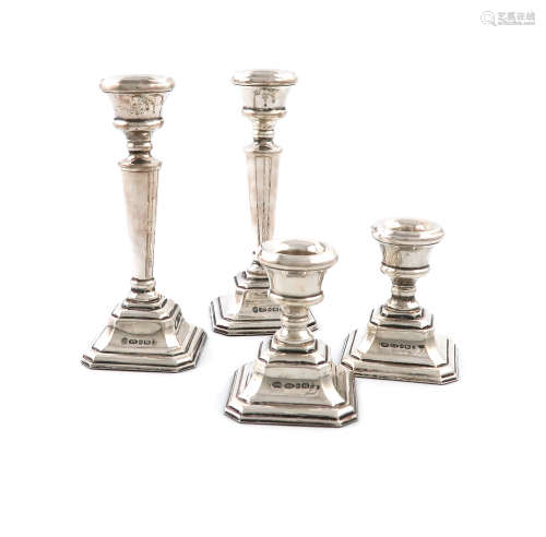 A pair of silver candlesticks and a matching pair of dwarf silver candlesticks, by L J Millington,