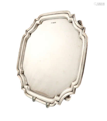 A silver salver, by Walker and Hall, Sheffield 1949, shaped square form, moulded border, on four bun