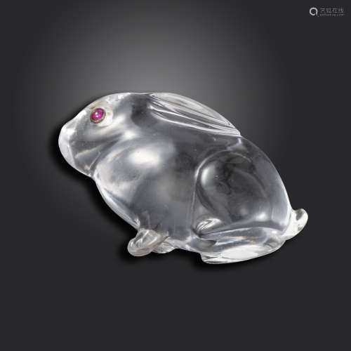 An early 20th century carved rock crystal seated rabbit, in the style of Fabergé, cabochon red stone