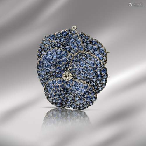 An American early 20th century pansy brooch pendant, centred with an old circular-cut diamond, the