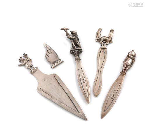 A collection of five silver page markers, comprising: one with a Trusty Servant finial, by F. J.
