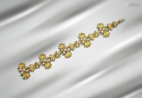 A diamond-set gold bracelet by Cartier, the five principal links of lobed foliate form, set with