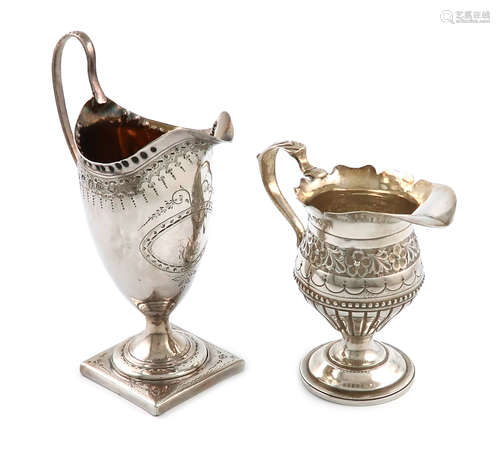 A George III silver cream jug, maker's mark worn, London 1787, helmet form, scroll handle, punch