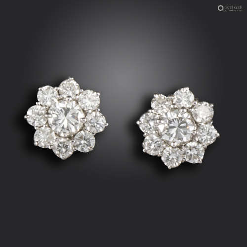 A pair of diamond cluster earrings, set with graduated round brilliant-cut diamonds in white gold,