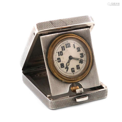 A silver travelling time-piece, by A. Wilcox, Birmingham 1932, rectangular form, hinged cover,