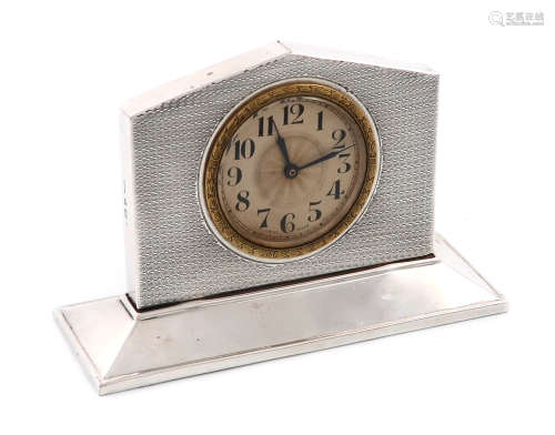 A silver clock, by A L Davenport Ltd., Birmingham 1929, rectangular arched form, engine-turned