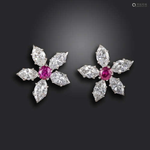A pair of ruby and diamond flower head cluster earrings, each centred with an oval shaped ruby