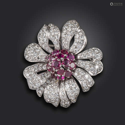 A ruby and diamond flower head brooch, 1950s, the centre set with circular-cut rubies, the petals