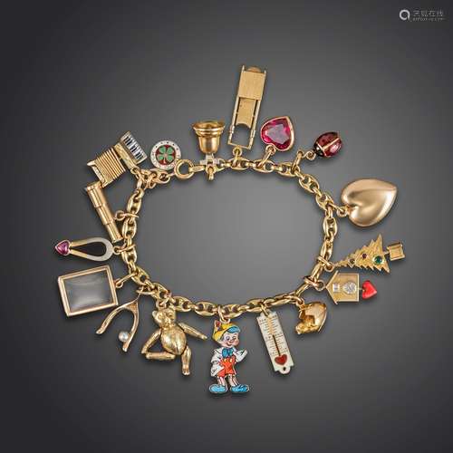 A gold anchor-link bracelet mounted with sixteen gold charms, including a Cartier charm depicting