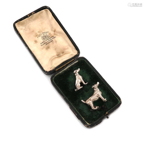 A pair of novelty silver dog menu card holders, by William Hornby, London 1910, one seated, the