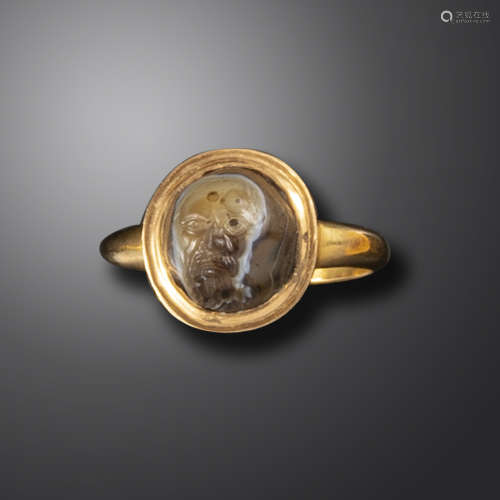 An 18th century domed sardonyx cameo of a bearded theatre mask, in a later gold ring, intaglio