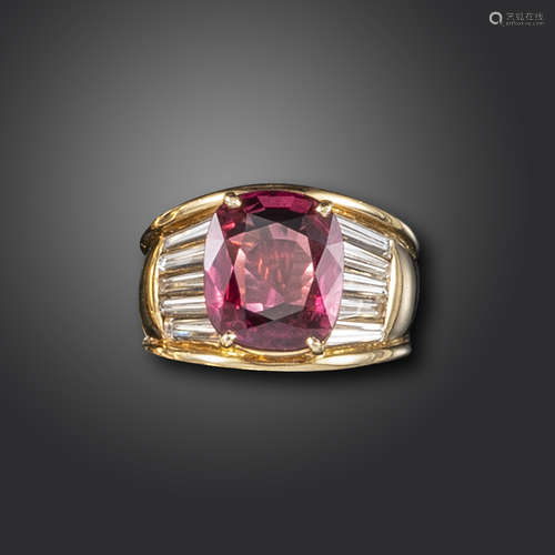 A ruby and diamond cluster ring, the cushion-shaped ruby weighs 4.92cts, with tapered baguette-