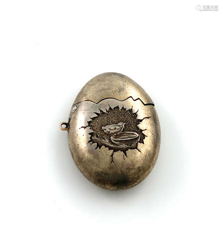 A French silver-gilt egg locket / travelling needle case, marked with control marks, compressed