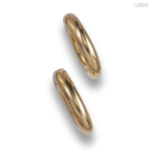 A pair of gold hoop earrings by Cartier, the hollow gold hoop clips with invisible spring-loaded