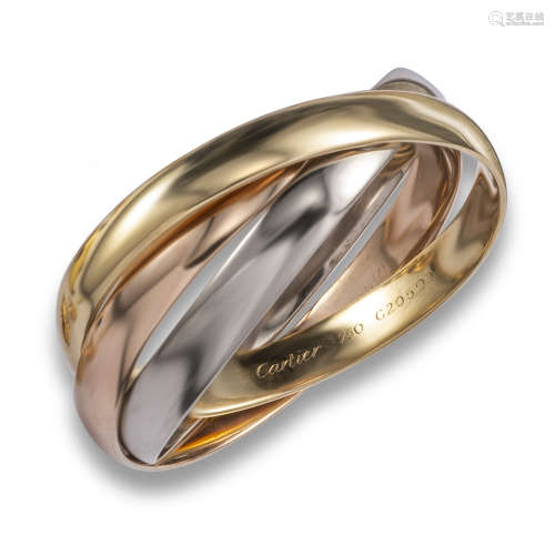 A gold trinity bangle by Cartier, the polished gold connecting bangles are in rose, yellow and white