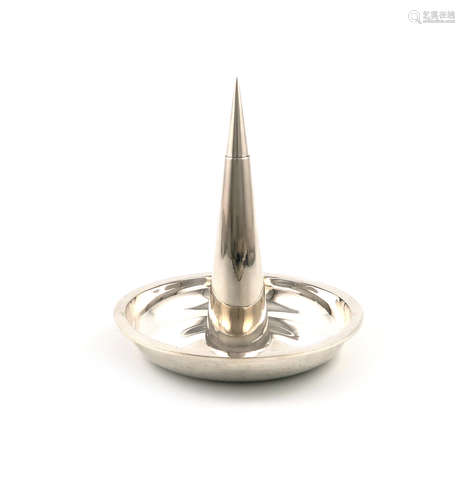 By Gerald Benney, a modern silver pricket candlestick, London 1963, the tapering central spike on