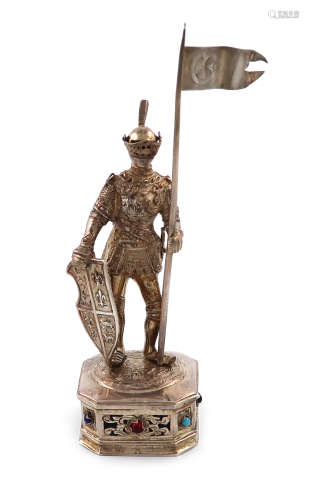 A German silver-gilt model of a knight, modelled in a standing position holding a lance and