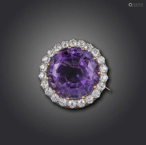 An Edwardian amethyst and diamond brooch, the circular-cut amethyst set within a surround of old