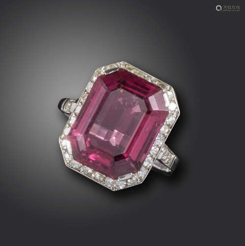 An Art Deco tourmaline and diamond ring, the emerald-cut pink tourmaline set within single-cut