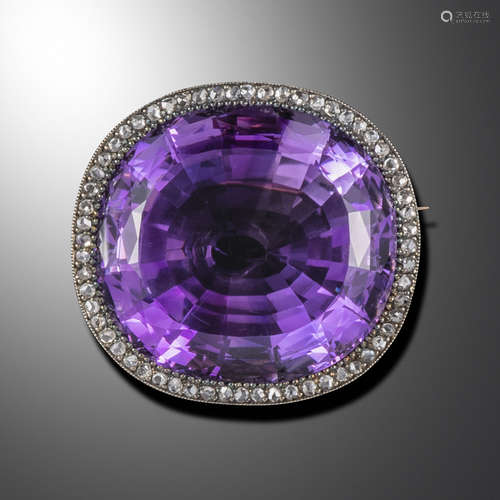 A late Victorian large amethyst and diamond brooch pendant, the cushion-shaped amethyst set within a