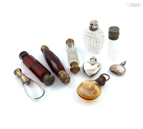 A collection of nine mounted glass scent bottles comprising: a silver-gilt double ended red glass