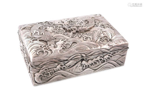 A Chinese silver box, rectangular form, the hinged cover embossed with a dragon within scroll waves,
