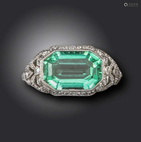 A French early 20th century emerald and diamond-set ring by Gabriel Falguieres, the octagonal-cut