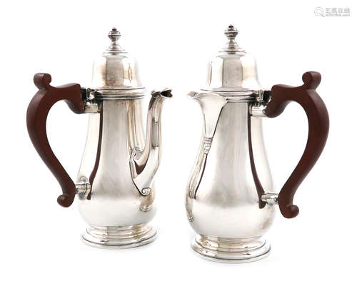 A pair of silver cafe au lait pots, by Mappin and Webb, Sheffield 1938, baluster form, side scroll