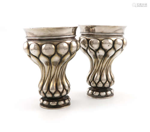 A pair of continental silver beakers, bearing pseudo 18th century Russian marks, tapering lobed