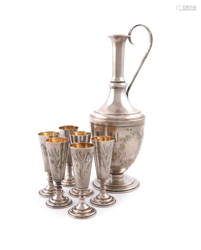 A Russian silver ewer and six vodka cups, 1927-1958, the ewer of baluster form, engraved foliate