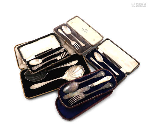A mixed lot of cased silver sets, comprising: a pair of fruit serving spoons, Sheffield 1933, a