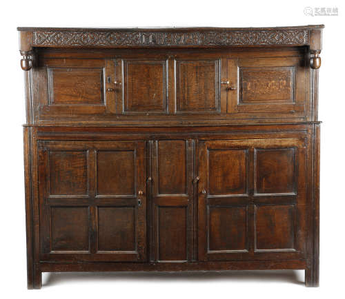 AN OAK PRESS CUPBOARD 17TH CENTURY AND LATER the frieze carved with stylised scrolls, initials '