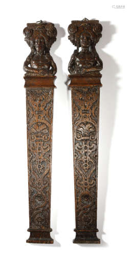 A PAIR OF 17TH CENTURY CARVED OAK CARYATYDS OR TERMS c.1620 each with a male figure supporting an