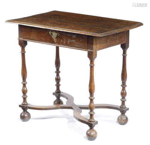A QUEEN ANNE OAK SIDE TABLE EARLY 18TH CENTURY the boarded top with a moulded edge, above a frieze
