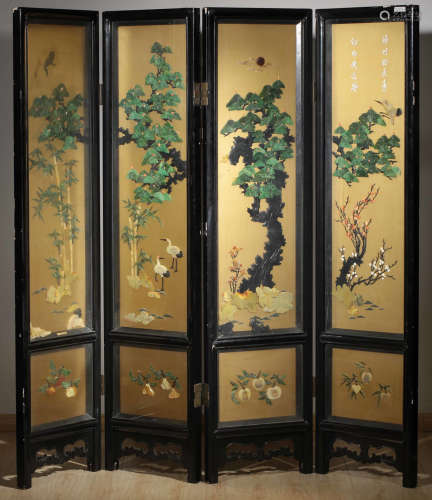 A BLACK LACQUER SCREEN CARVED WITH PINE AND CRANE