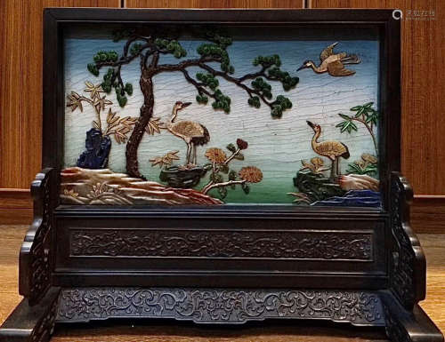 A ZITAN WOOD WITH LACQUER SCREEN CARVED WITH PINE AND CRANE