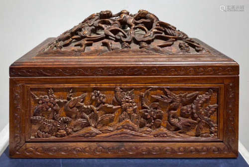 A TAN WOOD BOX CARVED WITH PATTERN