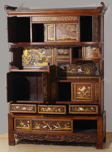 A WOOD CARVED CABINET