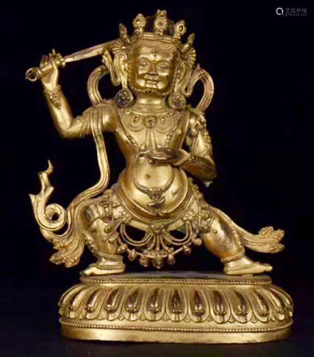 A TIBETAN GILT BRONZE ACALANATHA