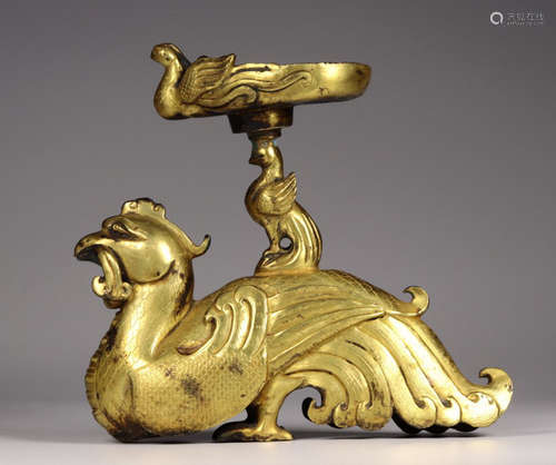 A GILT BRONZE CANDLE HOLDER SHAPED WITH PHOENIX