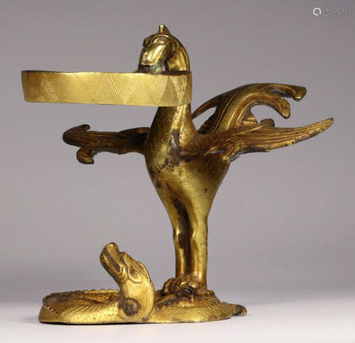 A GILT BRONZE CANDLE HOLDER SHAPED WITH BIRD