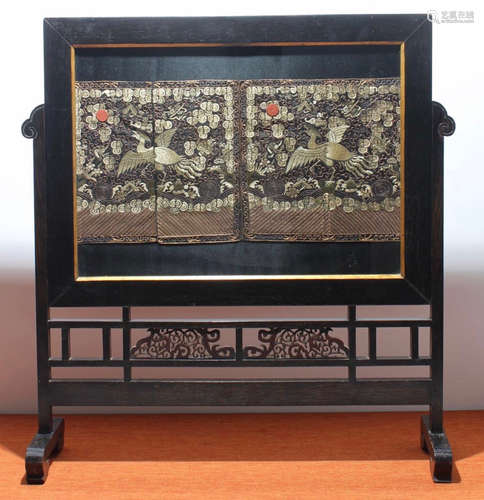 A WENGE WOOD SCREEN CARVED WITH CRANE