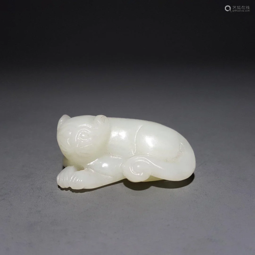 A CHINESE CARVED HETIAN JADE BEAST ORN…