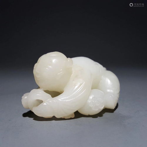 A CHINESE CARVED HETIAN JADE BOY ORNA…