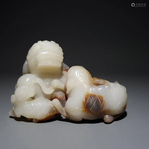 A CHINESE CARVED HETIAN JADE BEAST ORN…