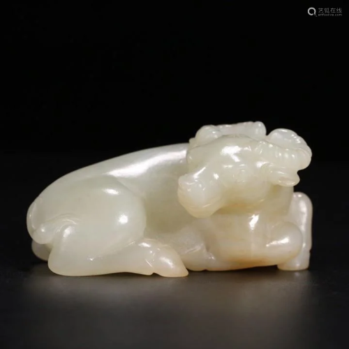 A CHINESE CARVED HETIAN JADE COW ORN…