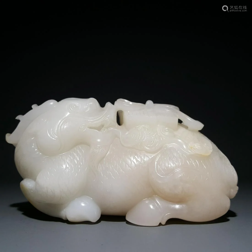 A CHINESE CARVED HETIAN JADE KYLIN ORN…